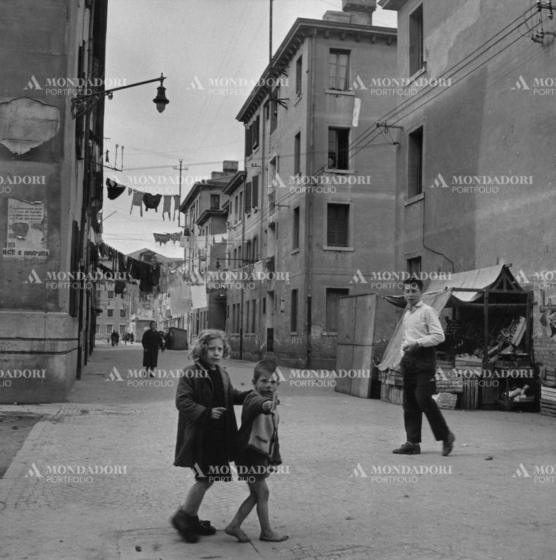 Some children walking in a street of Giudecca. Venice, March 1954 SPECIAL FEE  - CONTACT US FOR NOT EDITORIAL USAGE