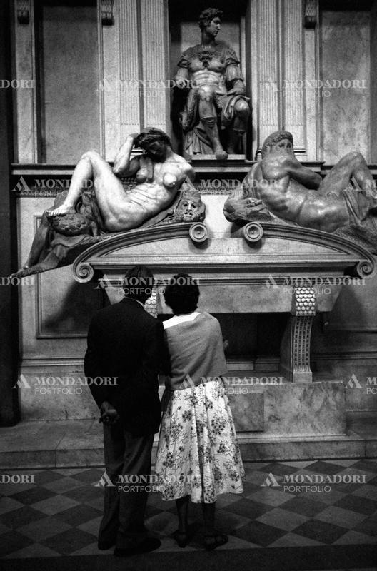 Two people observing the tomb of Giuliano de' Medici Duke of Nemours made by Michelangelo Buonarroti for the New Sacristy of San Lorenzo. Florence, 1950s SPECIAL FEE  - CONTACT US FOR NOT EDITORIAL USAGE