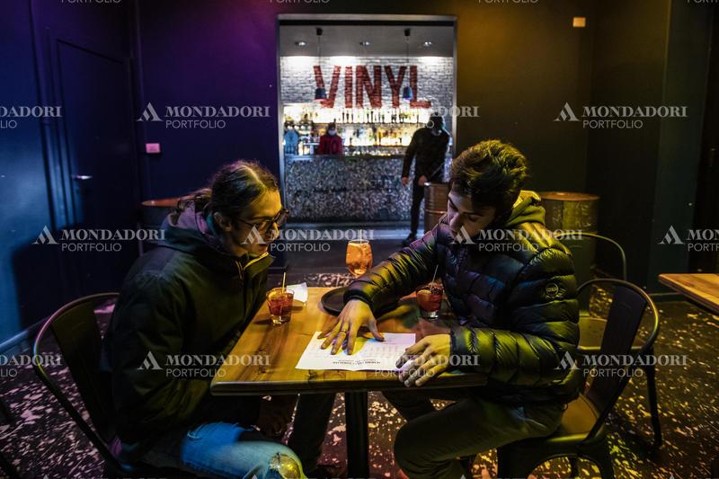 Two boys are studying sound engineering at the Vinyl Pub. Milan (Italy), February 10th, 2021
