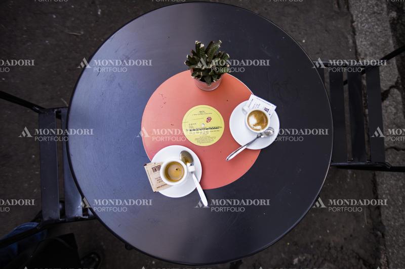 Two cups of coffee on a vinyl-shaped table. Rome (Italy), March 1st, 2021