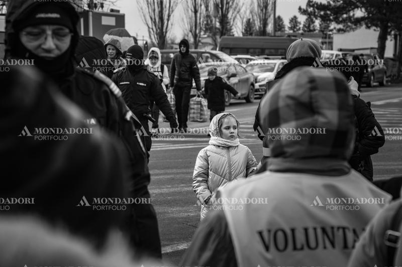 A Ukrainian woman is helped to enter the refugee reception tent. Siret (Romania), March 7th, 2022