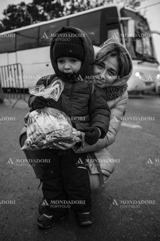 Portrait of a Ukrainian woman hugging her child.  Siret (Romania), March 8th, 2022