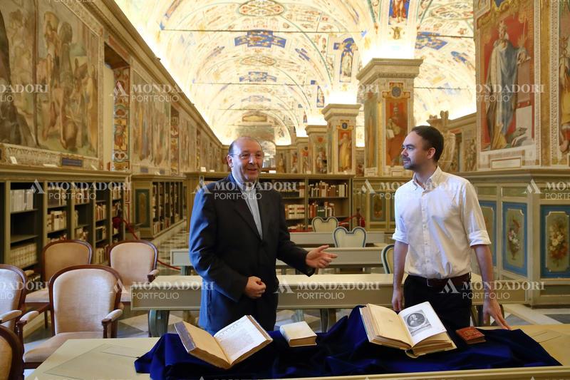 Father Mauro Mantovani S.D.B, Prefect of the Vatican Apostolic Library and the French writer Pierre Chambert-Protat showing some works by Blaise Pascal, French Catholic philosopher and mathematician, exhibited in the Sistine Hall of the Vatican Apostolic Library. Vatican City (Vatican), June 19th, 2023.