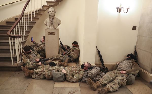Members of the U.S. National Guard sleep in the Capitol